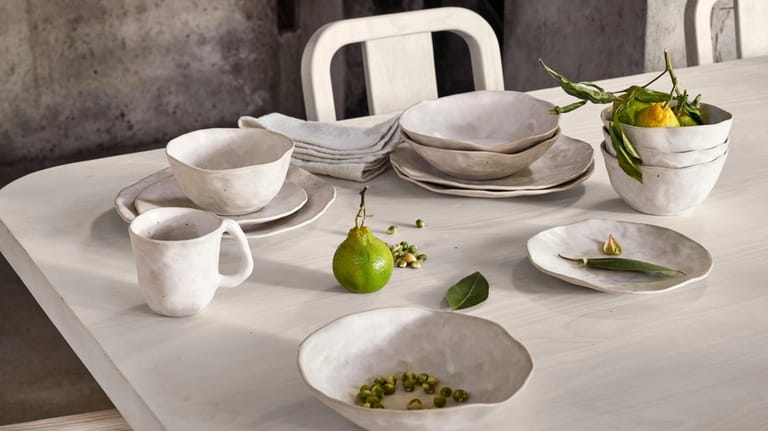 This image provided by Crate & Barrel shows dining plates,...