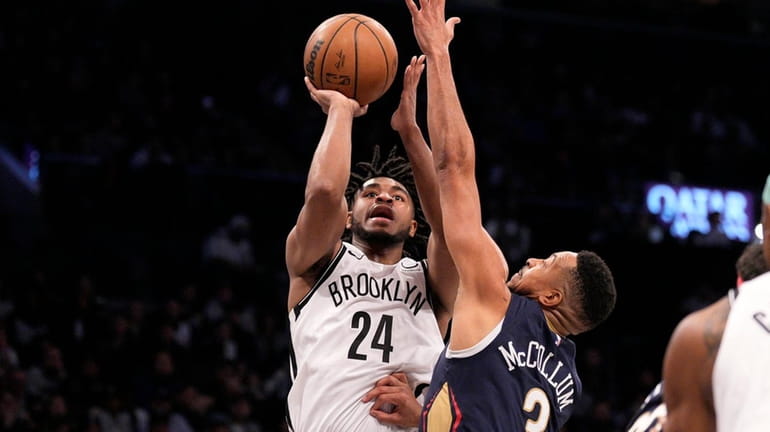 Cam Thomas of the Nets shoots over CJ McCollum of...