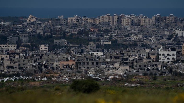Destroyed buildings stand in the Gaza Strip, as seen from...