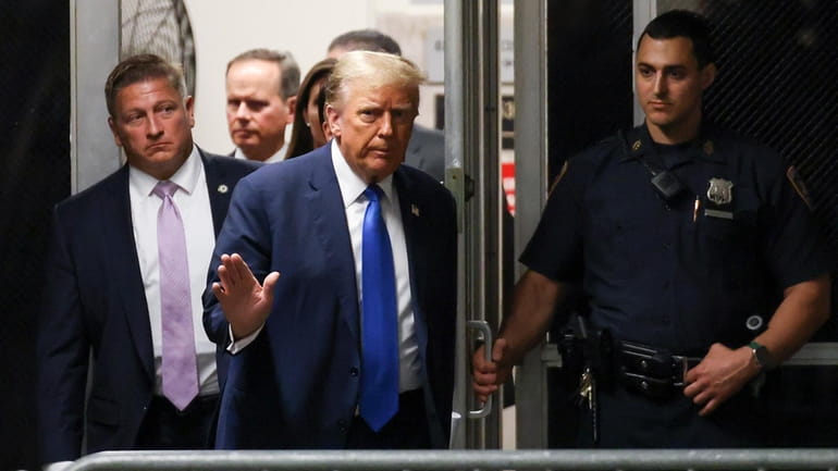 Former President Donald Trump returns to the courtroom after a...