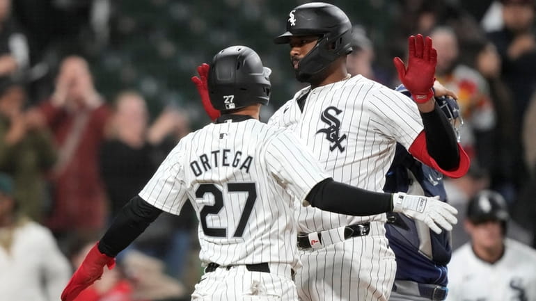 Chicago White Sox's Eloy Jiménez, right, celebrates after his two-run...
