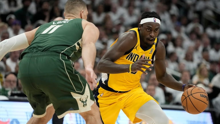 Indiana Pacers' Pascal Siakam tries to get past Milwaukee Bucks'...