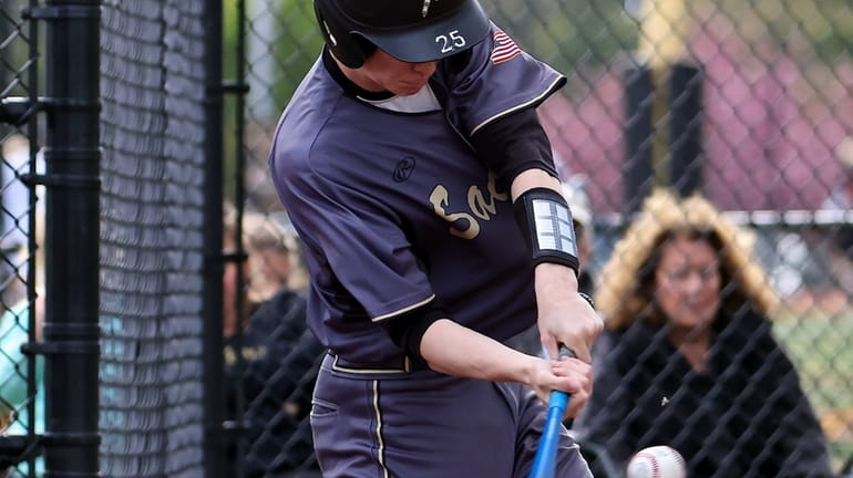 Sachem North's Zach DeMilt drives a single to the outfield against...