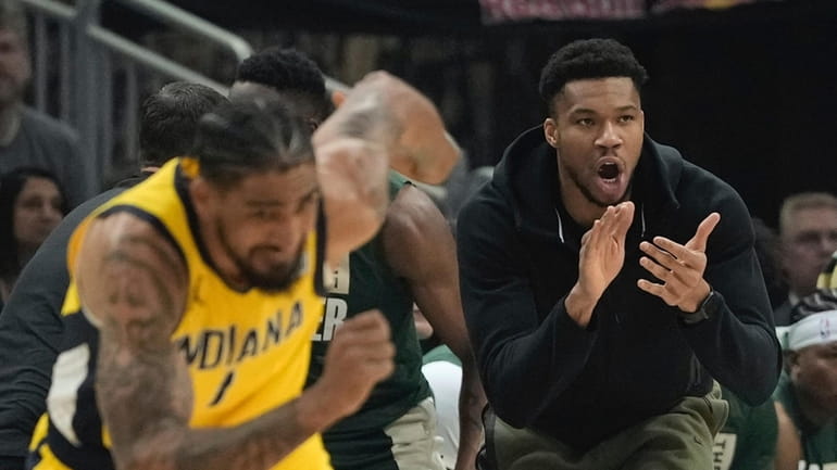Milwaukee Bucks' Giannis Antetokounmpo reacts from the bench during the...