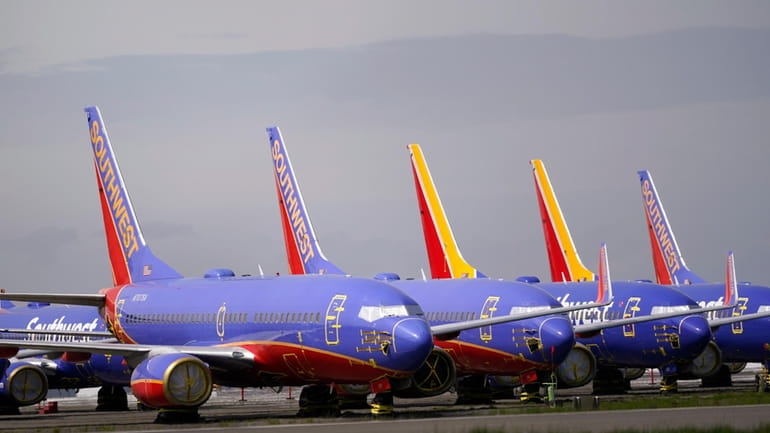 A line of Southwest Air Boeing 737 jets are parked...