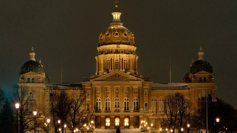 The Iowa Capitol is visible before sunrise, Jan. 12, 2024,...