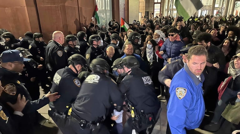 New York City Police Department officers arrest pro-Palestinian protesters outside...