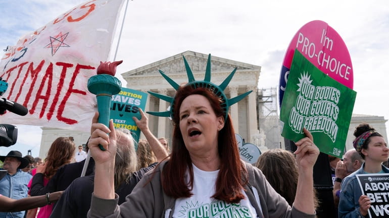 Abortion-rights activists rally outside the Supreme Court, Wednesday, April 24,...