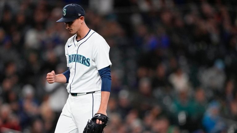 Seattle Mariners starting pitcher George Kirby walks off the field...