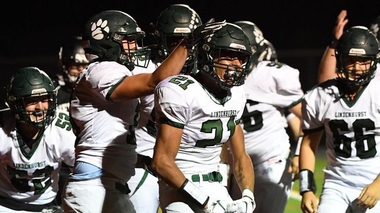 Lindenhurst's Jaden Barber (21) and teammates react after he rushes for...