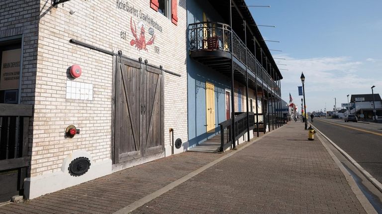 Freeport's Nautical Mile is deserted on March 20 as businesses,...