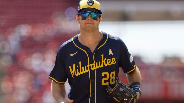 Milwaukee Brewers right fielder Brewer Hicklen runs off the field...