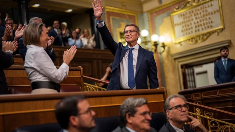 The leader of Spain's Popular Party Alberto Nunez Feijoo waves...