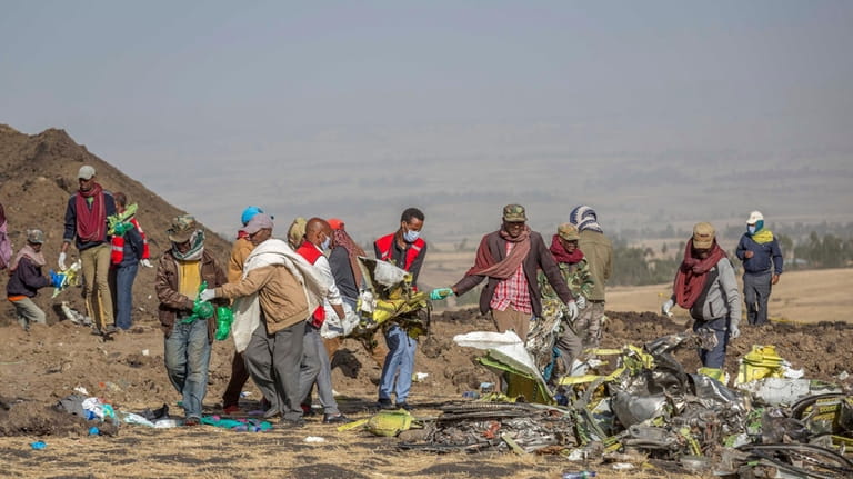 Rescuers work at the scene of an Ethiopian Airlines Boeing...