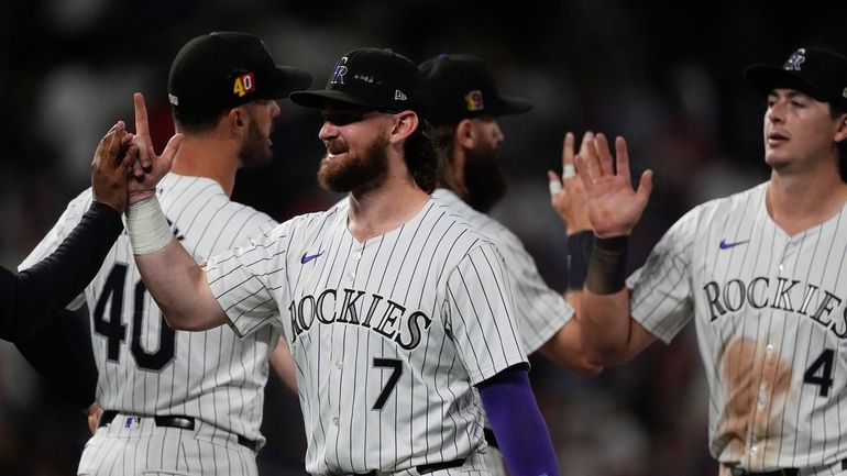 Colorado Rockies second baseman Brendan Rodgers (7) is congratulated after...