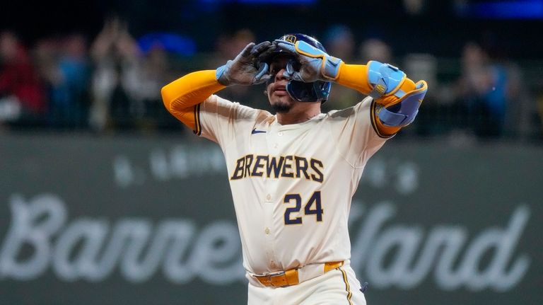 Milwaukee Brewers' William Contreras reacts after hitting a two-run scoring...