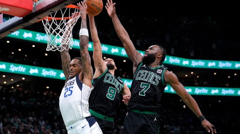 Dallas Mavericks forward P.J. Washington (25) is blocked by Boston...