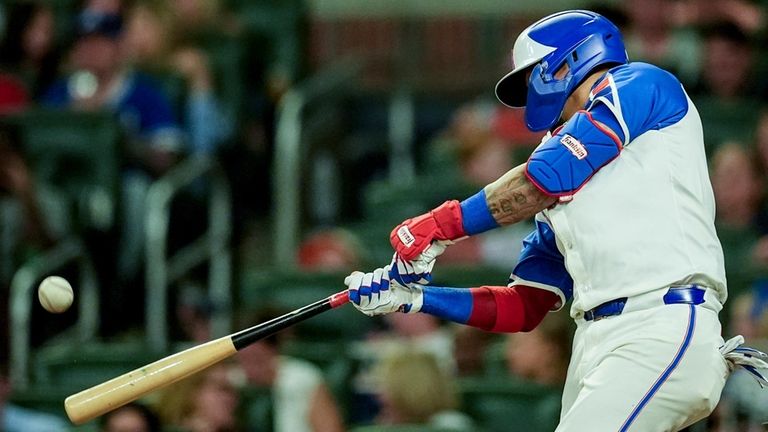 Atlanta Braves' Orlando Arcia (11) hits a solo homer against...