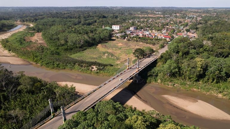 The Integration border bridge connects Assis, Brazil, left, and Iñapari,...