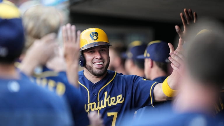 Milwaukee Brewers' Rowdy Tellez sits in the dugout during a