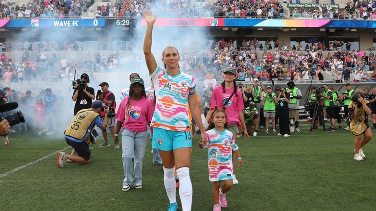 San Diego Wave's Alex Morgan waves before the start of...