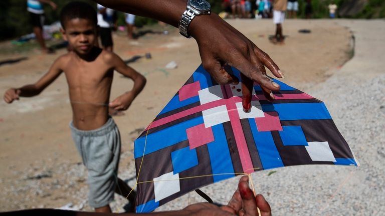 A kite-flier's finger is bloodied by a line during a...