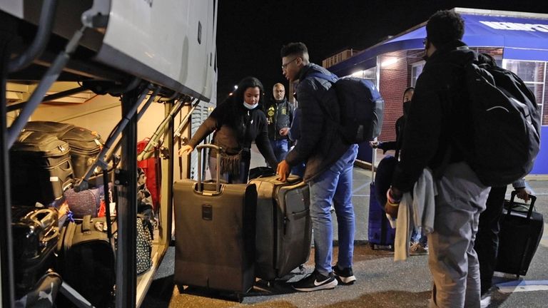 Students and chaperones load the bus early Saturday morning.