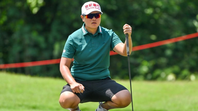 Peiyun Chien of Taiwan lines up a putt on the...
