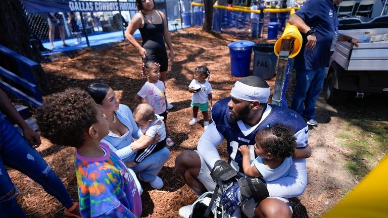 Dallas Cowboys linebacker Micah Parsons sits with his family after...