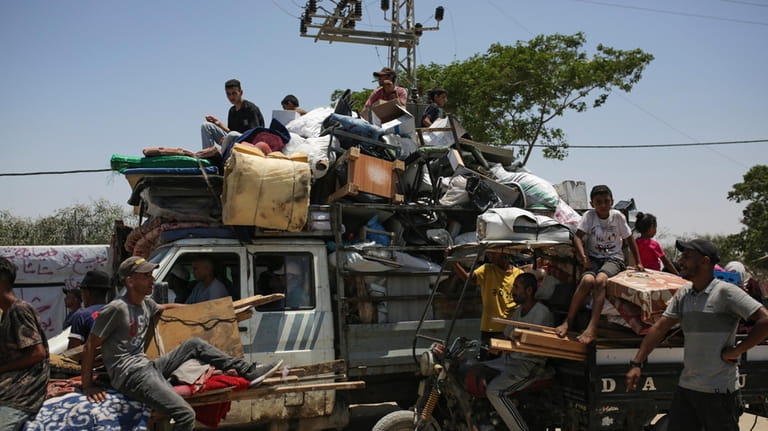 Palestinians arrive in the southern Gaza town of Khan Younis...