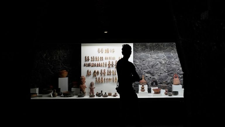 A visitor looks at pre-Hispanic ceramics on display at the...