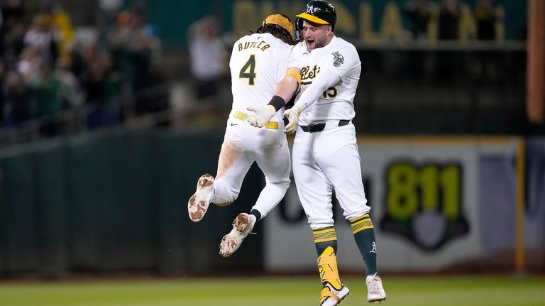 Oakland Athletics' Seth Brown (15) celebrates his game-winning single with...