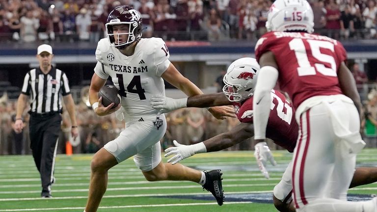 Texas A&M quarterback Max Johnson (14) runs against Arkansas linebacker...