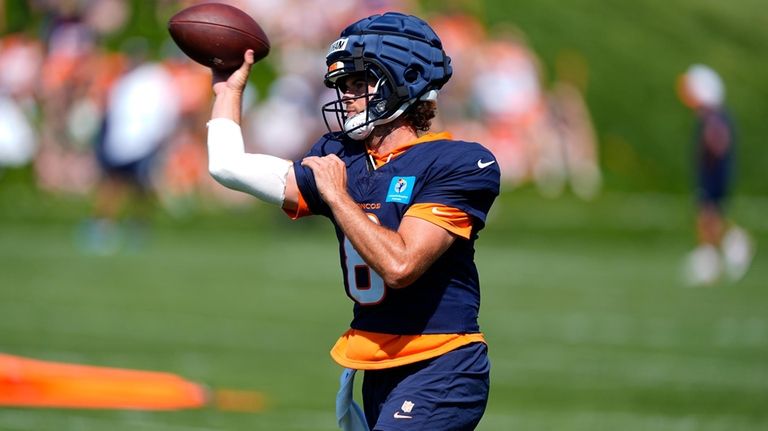 Denver Broncos quarterback Jarrett Stidham takes part in drills at...