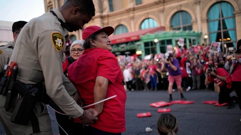 A Las Vegas police officer arrests a member of the...