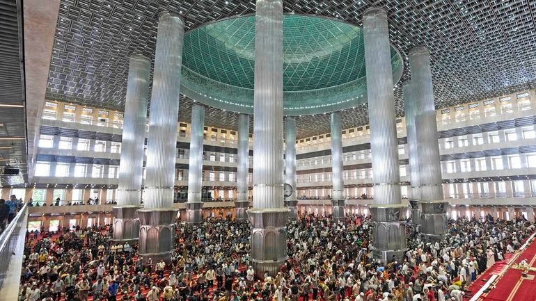 Muslim men attend Friday prayer at Istiqlal Mosque in Jakarta,...