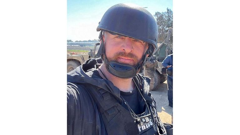 Reuters safety advisor Ryan Evans takes a selfie while working...