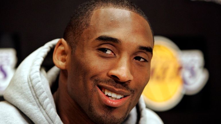 Los Angeles Lakers basketball star Kobe Bryant smiles as he...