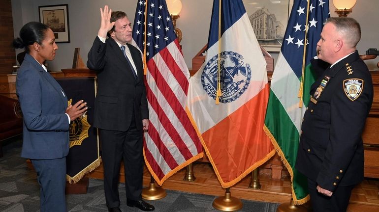 Thomas Donlon, center left, is sworn in as interim NYPD...