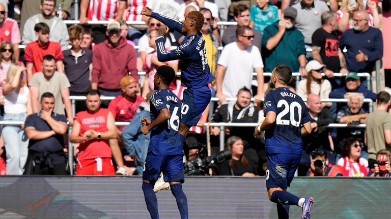 Manchester United's Marcus Rashford, center, celebrates after scoring his side's...