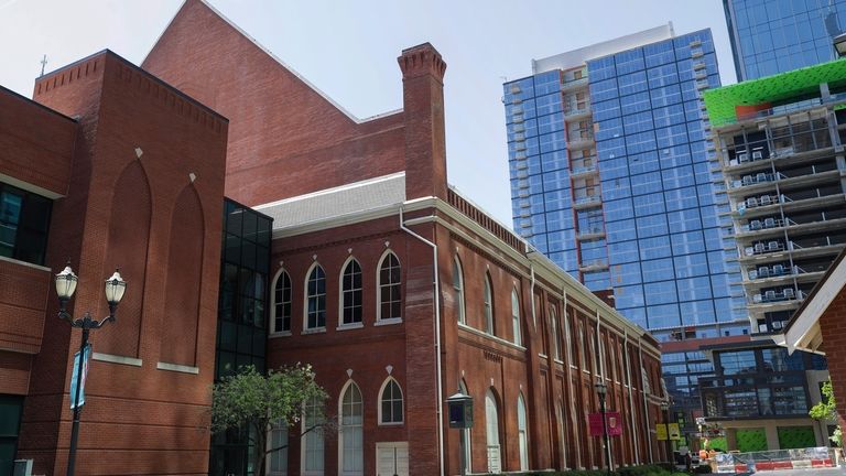 The Ryman Auditorium is surrounded by newer buildings in Nashville,...