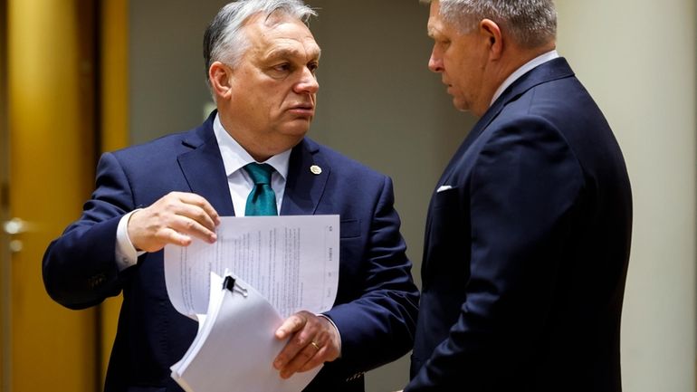 Slovakia's Prime Minister Robert Fico, right, talks to Hungary's Prime...