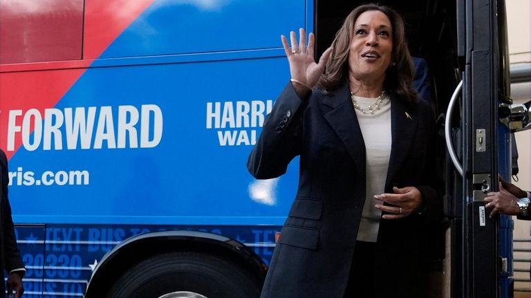 Democratic presidential nominee Vice President Kamala Harris waves as she...