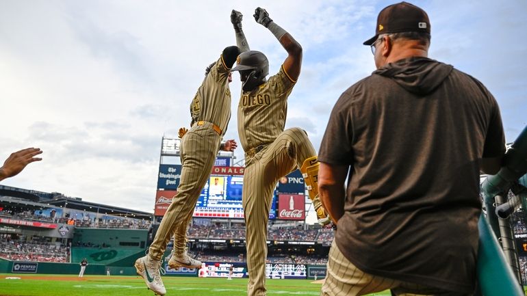 San Diego Padres' Jurickson Profar, center, celebrates his two-run home...