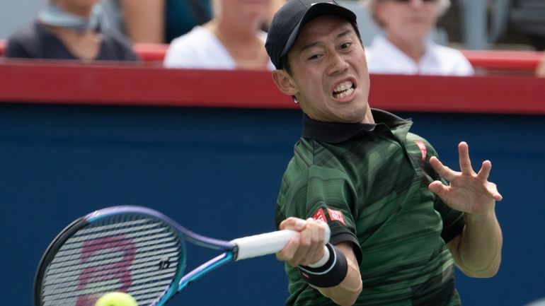 Japan's Ken Nishikori returns a shot to USA's Alex Michelson...