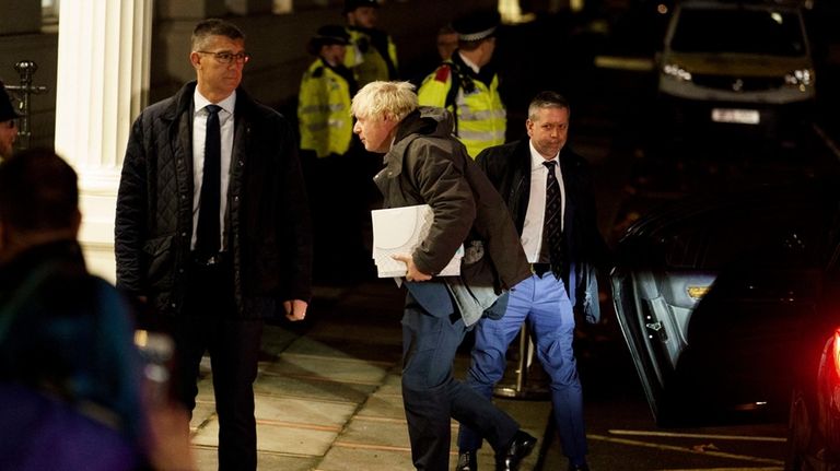 Britain's former Prime Minister Boris Johnson arrives at the Covid-19...