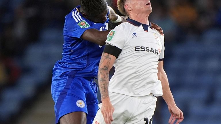 Leicester City's Caleb Okoli, left, and Tranmere Rover's Harvey Read...