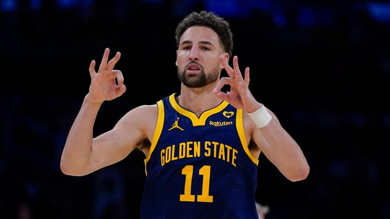 Golden State Warriors guard Klay Thompson gestures after making a...