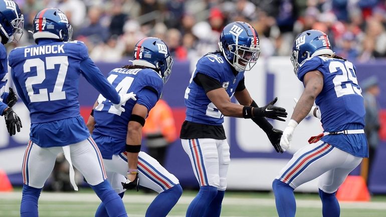 Jason Pinnock, Nick McCloud, Adoree' Jackson and Xavier McKinney of the Giants celebrate...