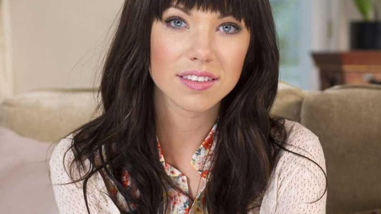 Canadian singer Carly Rae Jepsen poses for photographs following an...
